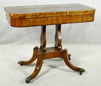 A Regency rosewood card table with foldover baize lined top on twin lyre shaped supports resting