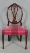 A 19th century mahogany chair with carved swag and ribbon detail to the back raised on square