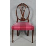 A 19th century mahogany chair with carved swag and ribbon detail to the back raised on square