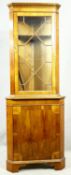 A Georgian style yew wood two section corner cabinet. H.213 W.70 D.48