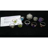 Ten gemset rings, one with certificate. To include a 9ct yellow gold peridot ring, amethyst ring,