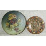A large 19th century hand decorated oil on metal floral wall hanging display dish and an Eastern