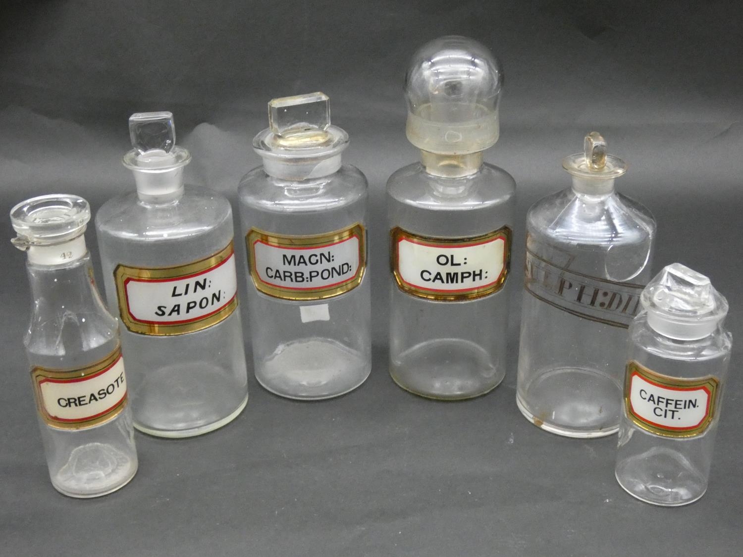 A miscellaneous collection of six 19th century apothecary's jars with stoppers, various labels, some