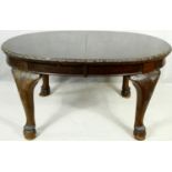 An early 20th century mahogany Georgian style dining table with extra leaf and wind out mechanism on