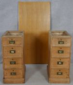 A pair of 19th century pine military style pedestals with inset brass handles along with a modern