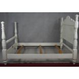 A painted American Colonial style bedstead to take a 5ft mattress.