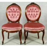 A pair of 19th century carved mahogany side chairs in deep buttoned upholstery on cabriole supports.