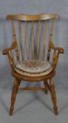 A late 19th century beech framed stick back kitchen armchair on turned stretchered supports. H.99cm
