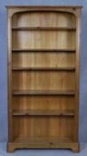 A full height floor standing pine open bookcase with arched upper section on bracket feet. H.186 W.