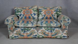 A two seater sofa in polychrome Chinese design upholstery. H.75 W.160 D.97cm