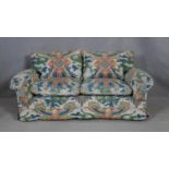 A two seater sofa in polychrome Chinese design upholstery. H.75 W.160 D.97cm