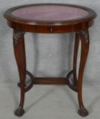 A C.1900 mahogany vitrine with original piped silk lining raised on slender cabriole supports with