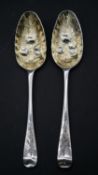A pair of 19th century silver berry spoons with engraved floral design to the handle and impressed
