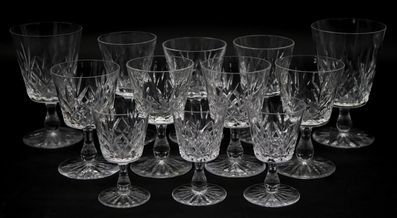 A collection of twelve glass sherry glasses with stylised foliate design and star cut bases. H.13cm