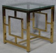 A contemporary brass and glass occasional table. H.54.5 L.50 W.50cm