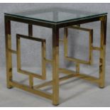 A contemporary brass and glass occasional table. H.54.5 L.50 W.50cm