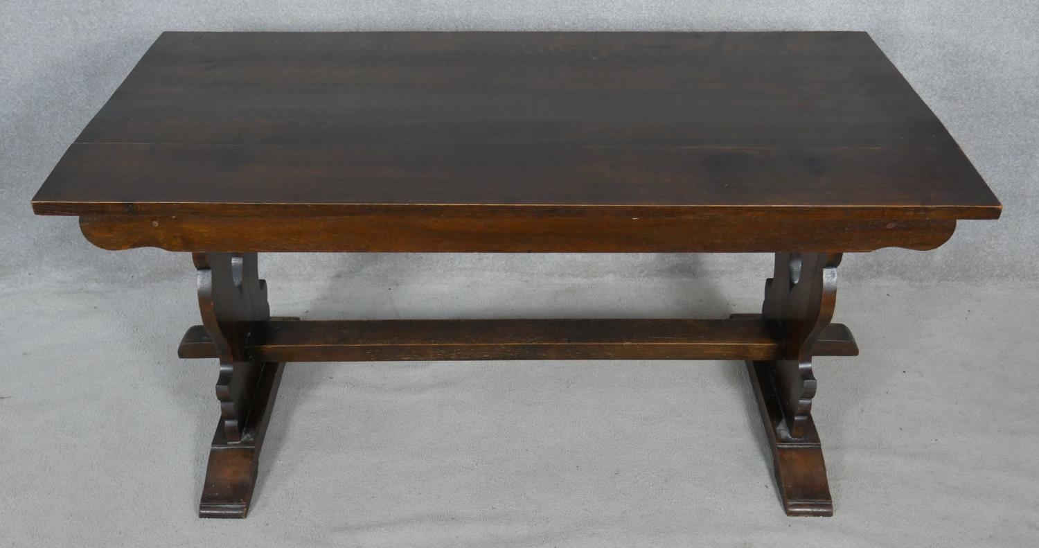 A Continental style refectory dining table on pierced stretchered trestle supports resting on a - Image 2 of 3