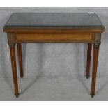 A late 19th century French Empire style mahogany and brass inlaid card table with fold over top