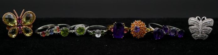 A collection of ten gemset silver rings with certificates. Including a lemon quartz and rhodolite