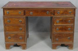 A 19th century mahogany three section pedestal desk with inset leather top resting on bracket