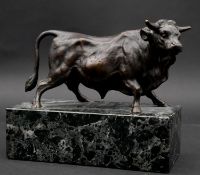 A bronze figure of a bull on veined marble plinth. H.13.5 L.16 W.7.5cm