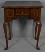 A small mid Georgian burr walnut and crossbanded lowboy on four cabriole supports each with