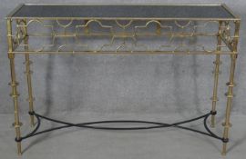 A contemporary gilt metal console table with fretwork frieze on stretchered supports. H.80 W.120 D.