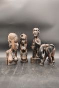 A collection of four wooden African tribal carvings, of figures and an elephant. H.38 W.7cm (