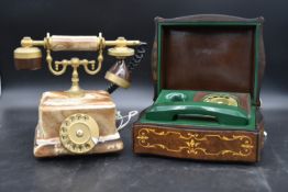 An alabaster and brass telephone in the antique style and a vintage green telephone cased in a