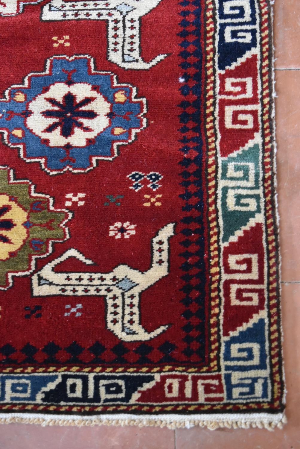 A Kazak design runner with stylised flowerhead and animal motifs across the madder ground within - Image 3 of 4