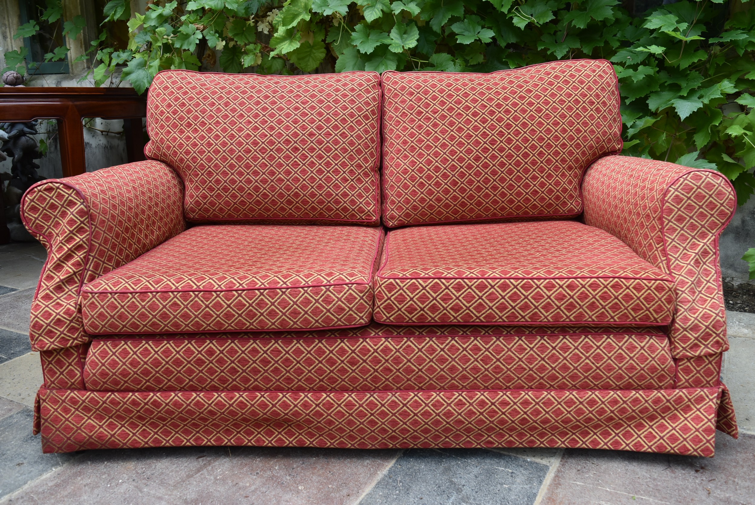 A two seater sofa in geometric upholstery. H.78 W.170 D.49cm