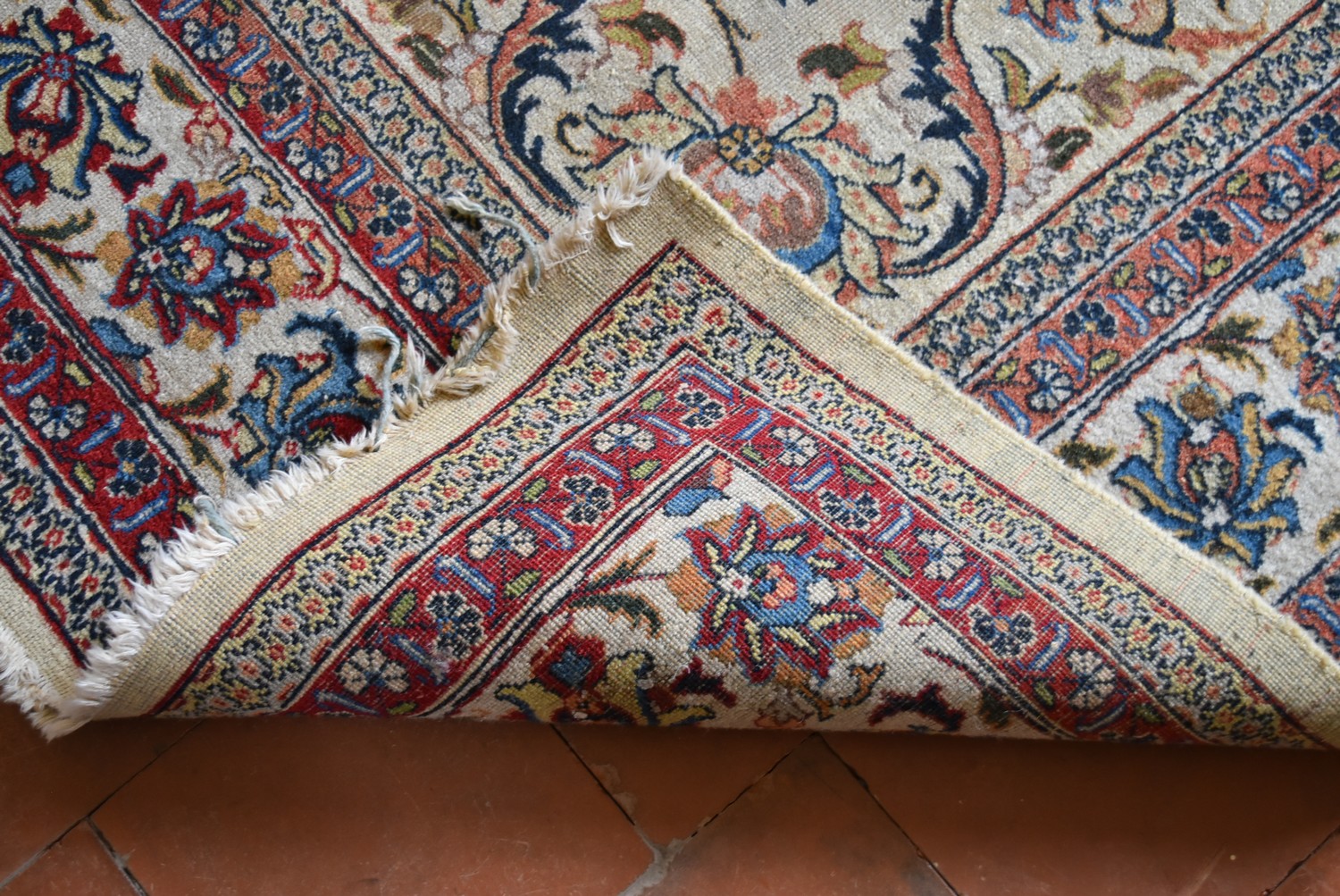 An old Persian Tabriz carpet with a repeating scrolling foliate design on a cream field within - Image 4 of 4