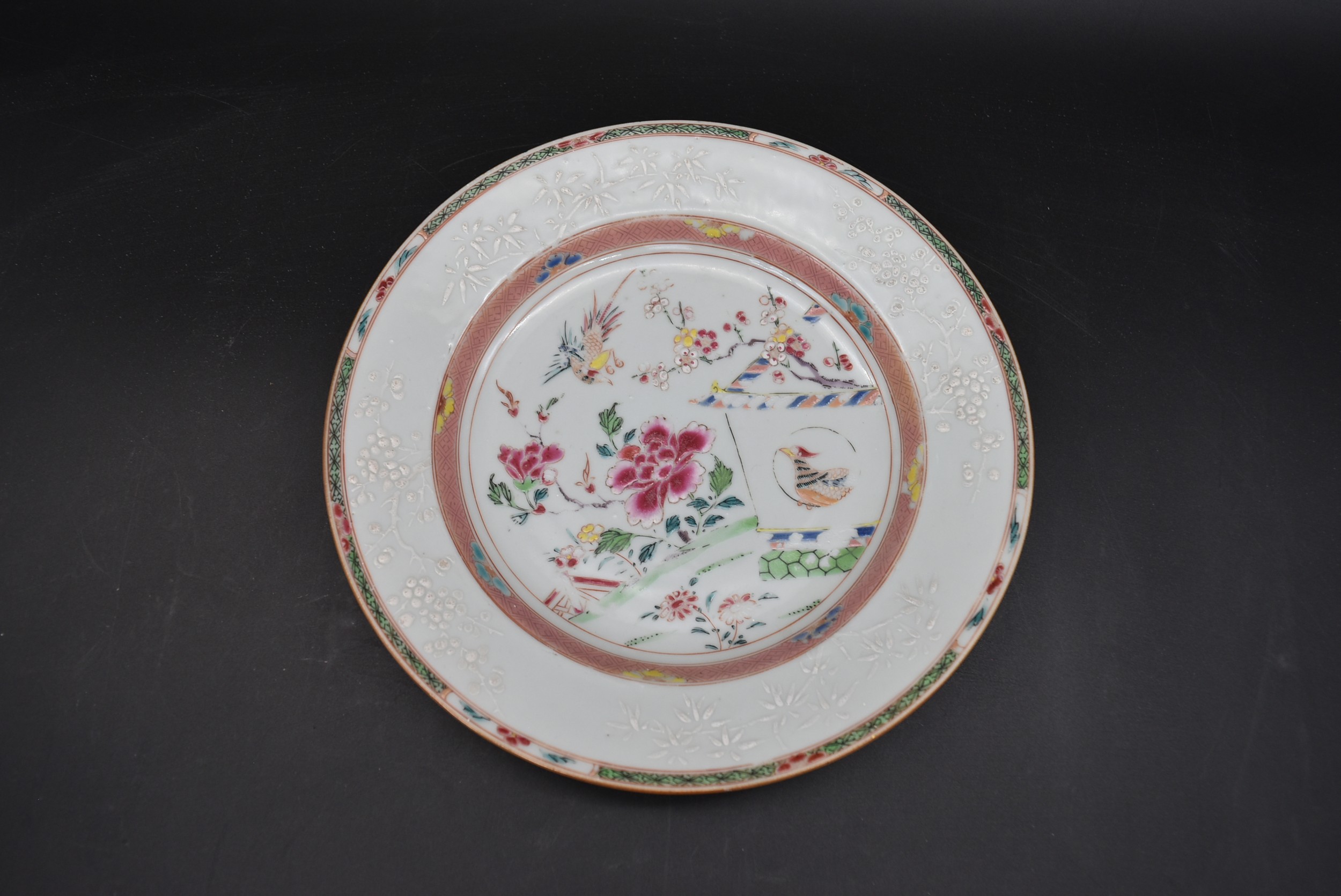 An 18th century Famille Rose Chinese glazed porcelain plate with cuckoo and house design with