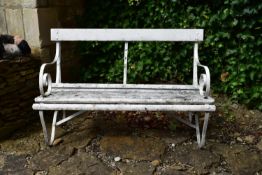 A wrought iron garden bench with scroll arms and planked seat. H.85 W.123 D.55cm