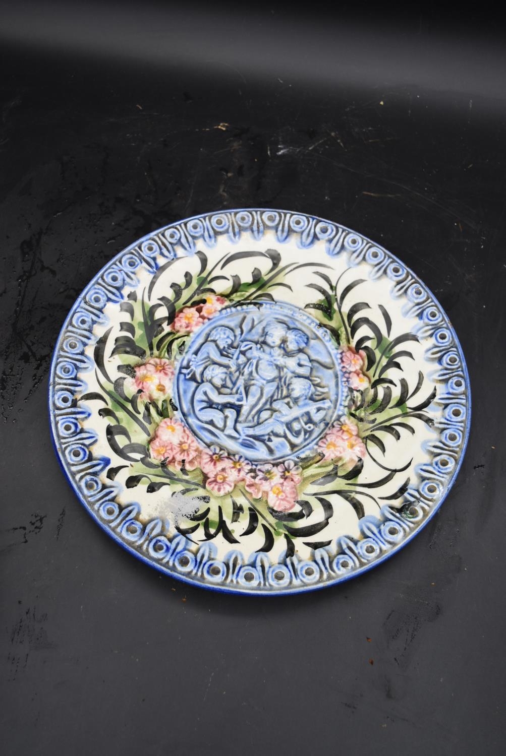 A Chinese blue and white plate and a Majolica plate decorated with cherubs. Dia.31cm (largest) - Image 2 of 6