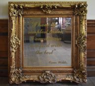 A gilt framed wall mirror in a heavy Rococo style frame, the bevelled plate with Oscar Wilde