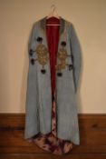 An Asian cotton robe with patterned interior, embellished with gold thread brocade and silk