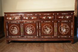 A Chinese hardwood sideboard with profuse all over mother of pearl inlay. H.88 W.184 D.57cm