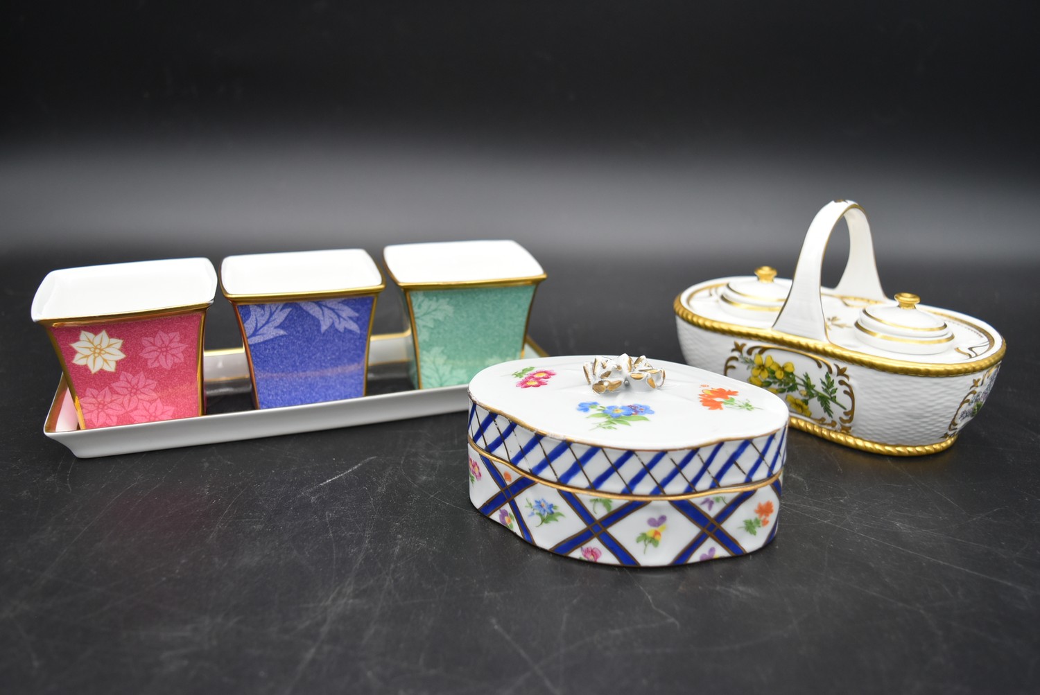 A Continental porcelain hand gilded and decorated lidded caddy, a twin lidded Spode basket and a set