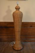 A vintage wicker standard lamp of shaped bulbous form. H.138cm