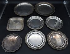 A set of four silver plated trays, two similar trays with gadrooned edges and two engraved trays.