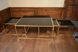 A nest of contemporary brass framed graduating occasional tables with drop in plate glass tops. H.57