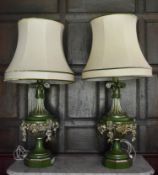 A large pair of swag carved painted and gilt table lamps and shades. H.110cm W.30cm