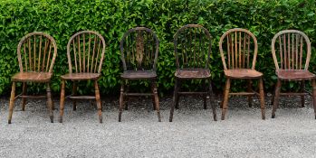 A collection of 6 country Windsor chairs with classical hoop back and spindles and one with