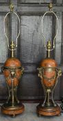 A pair of French Empire style faux marble table lamps with gilt metal ram's head detail. H.77cm W.