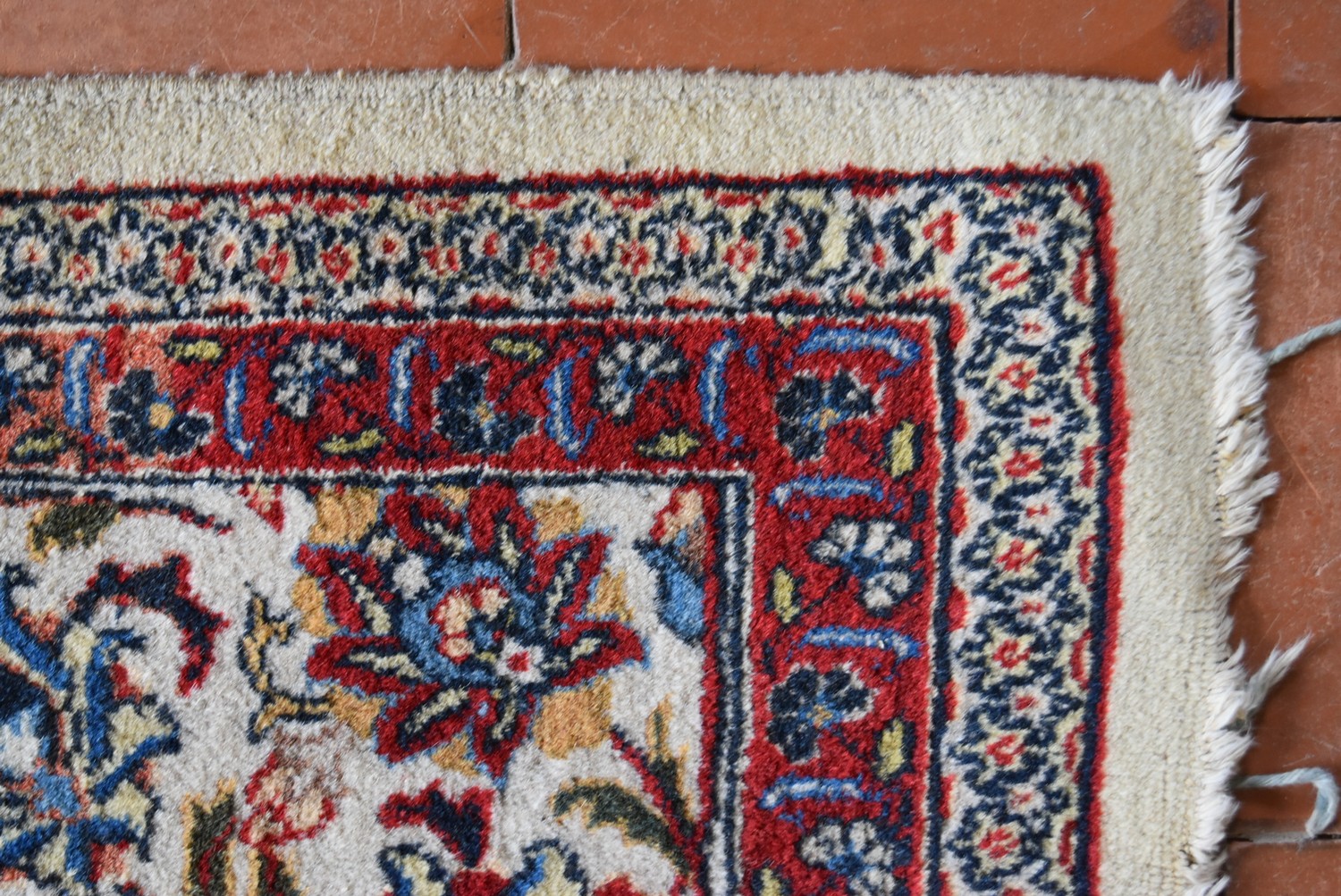 An old Persian Tabriz carpet with a repeating scrolling foliate design on a cream field within - Image 3 of 4