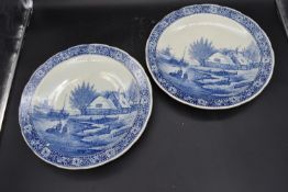 A pair of Dutch blue and white plates with maker's mark to base. Dia.39cm