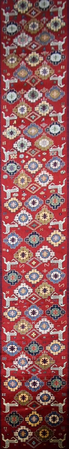 A Kazak design runner with stylised flowerhead and animal motifs across the madder ground within - Image 2 of 4