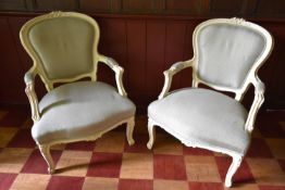 A pair of Louis XV style fauteuils with white painted frames in pale woven upholstery. H.95 W.