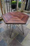 A stained pine conservatory table on metal hairpin base. H.76 W.106cm